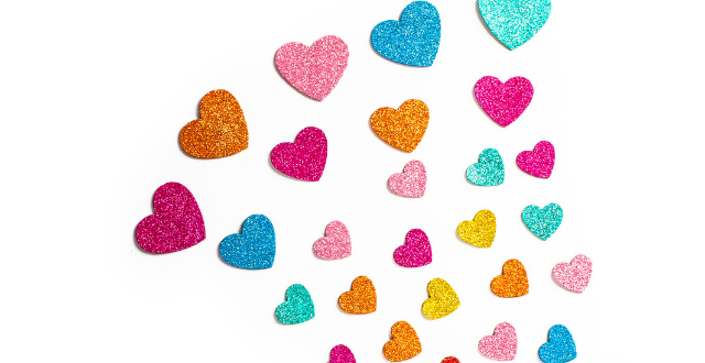 Glitter Hearts in various colors spread out on a white background