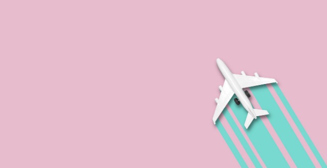 White toy airplane on pink and teal background