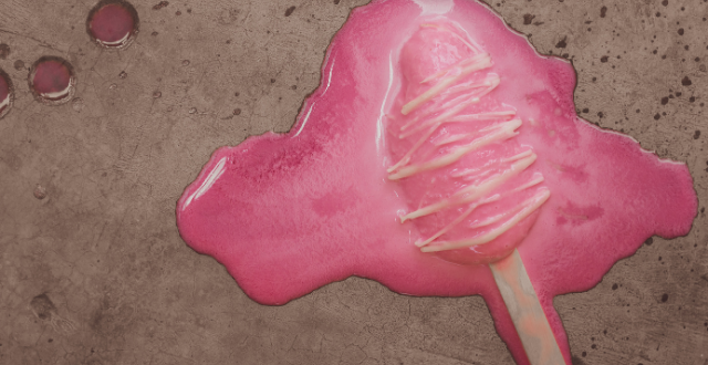 Melted pink popsicle on the sidewalk