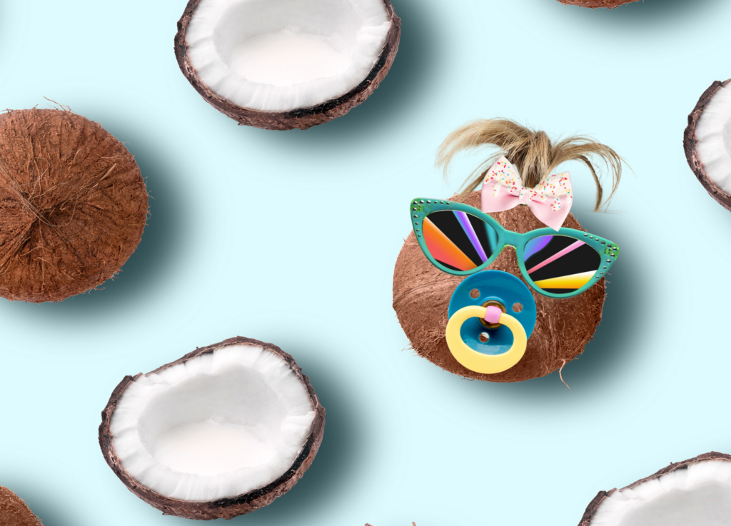 A coconut dressed up like a baby in sunglasses and a pacifier sits on a blue background. Other whole and half coconuts are around it. Coconut baby is my and my husband's secret code word for "get off your phone!"